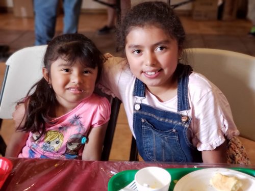 Two girls smiling after eating at the Switchpoint community soup kitchen