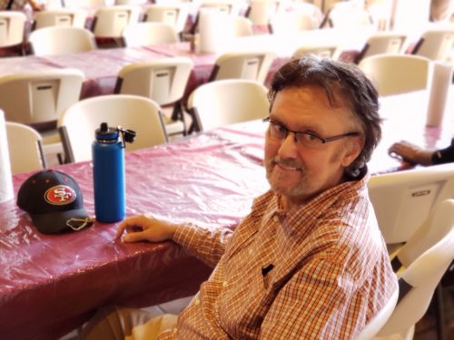 Photo of man sitting at table at Switchpoint community resource center soup kitchen